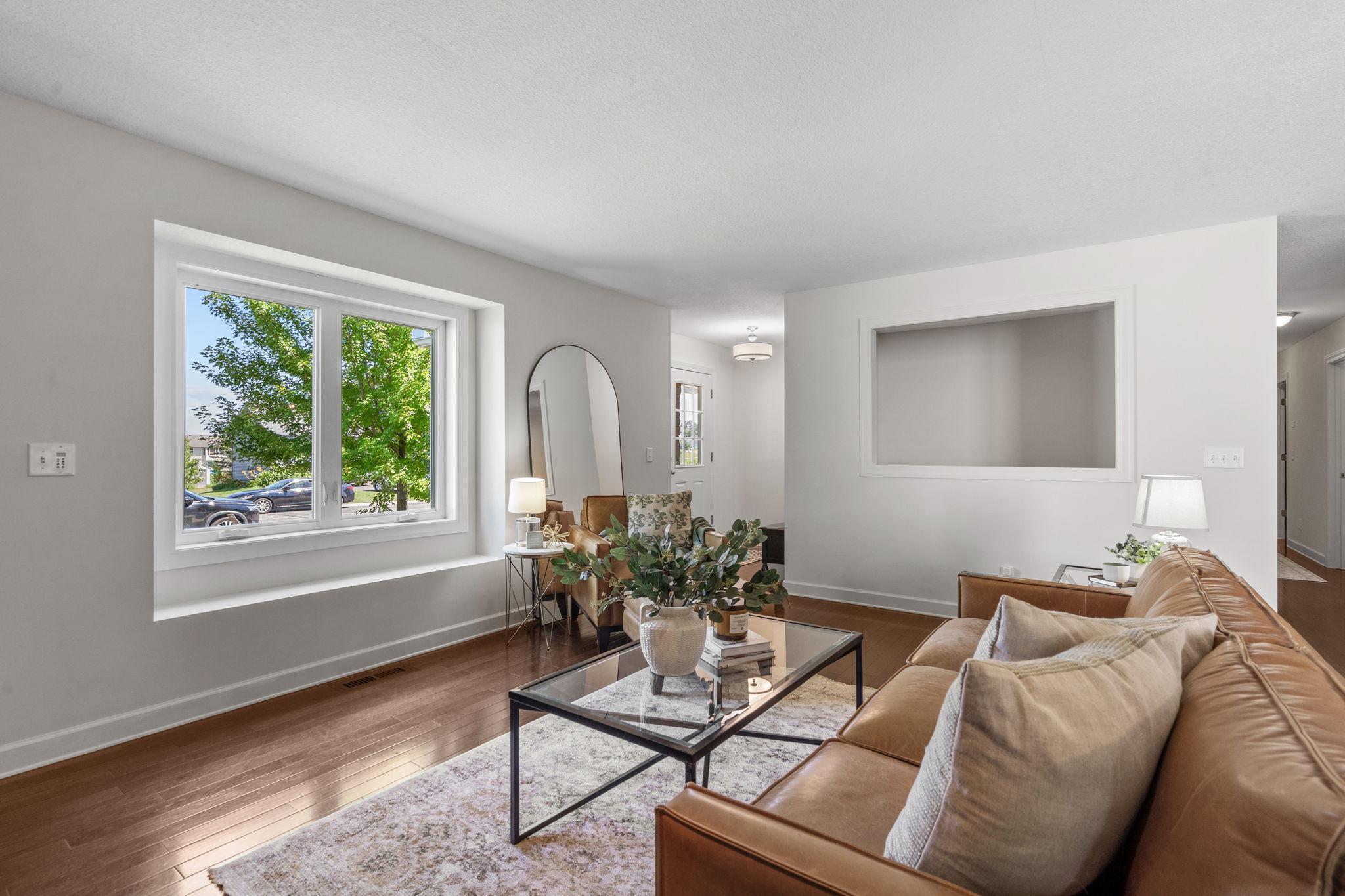Light-filled living room with oversized picture window and window seating