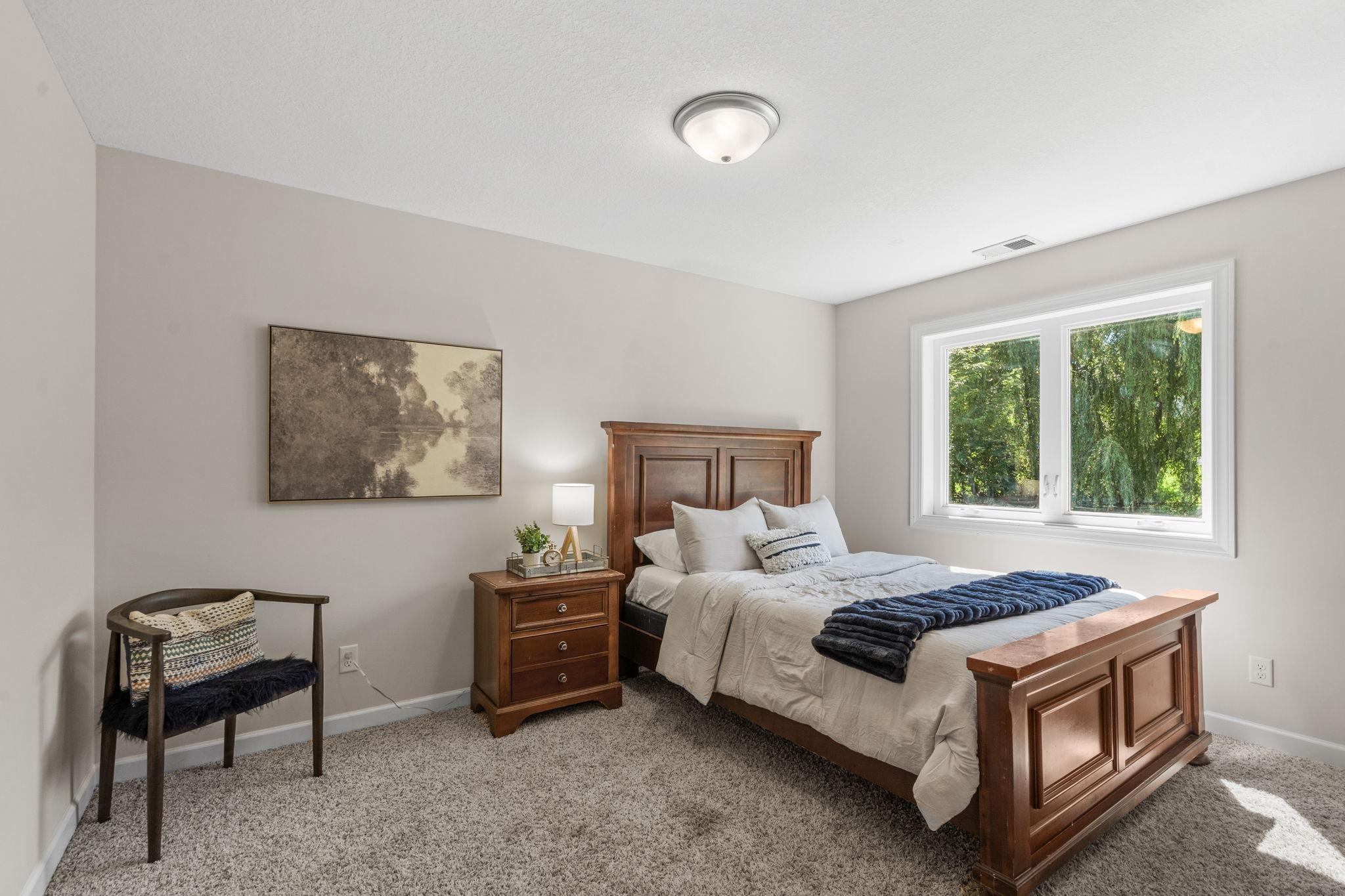Lower level bedroom with backyard views.