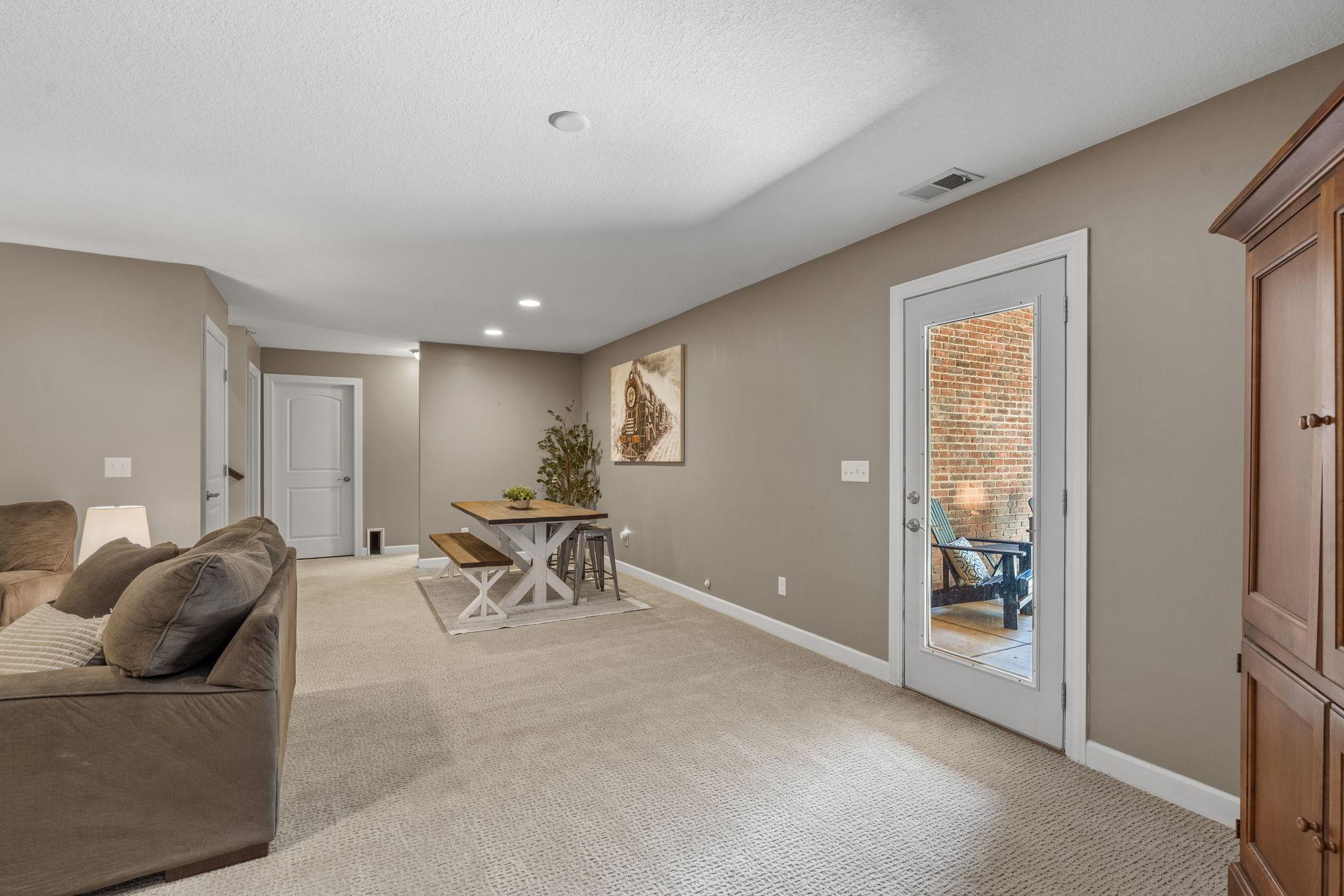 Walkout access seamlessly connects indoor living to the backyard while filling the space with natural light.