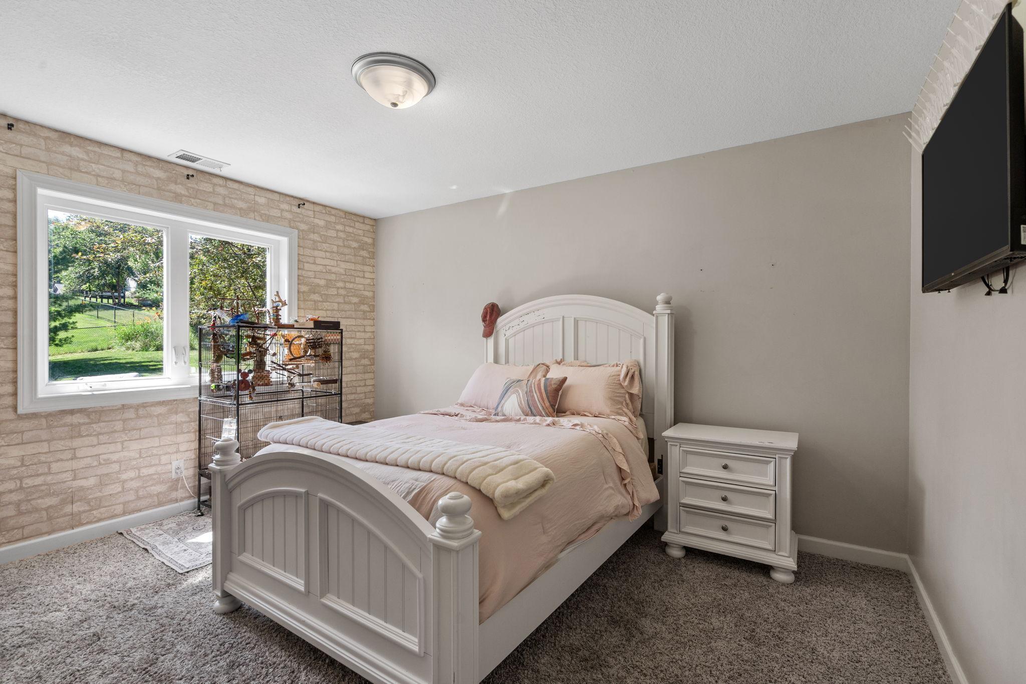 Lower level bedroom with backyard views.