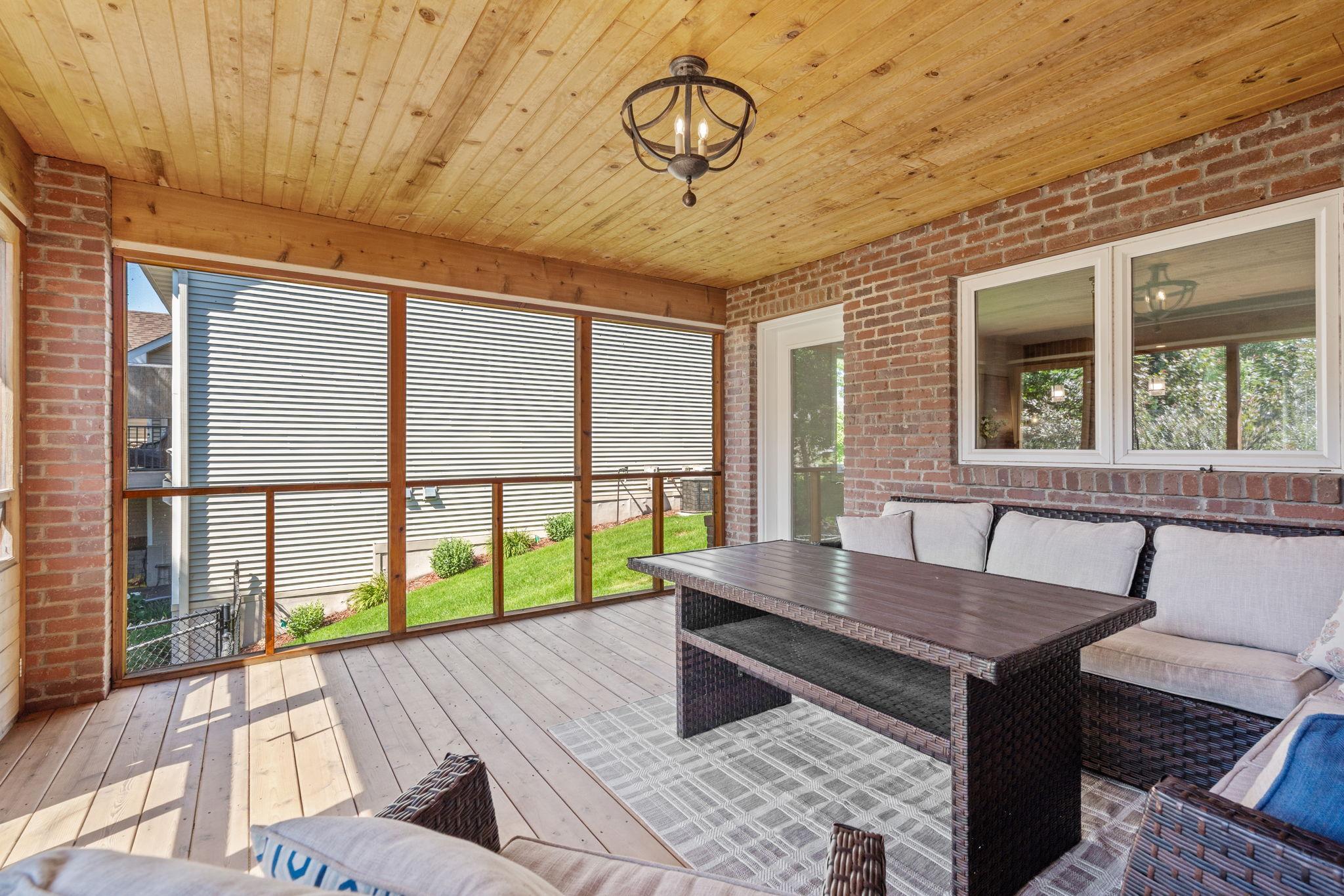 Screened porch offers the perfect space to relax outdoors.