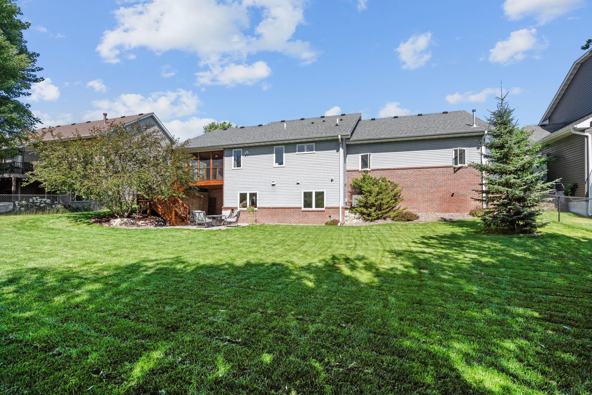 Large backyard with open green space and scenic surroundings.