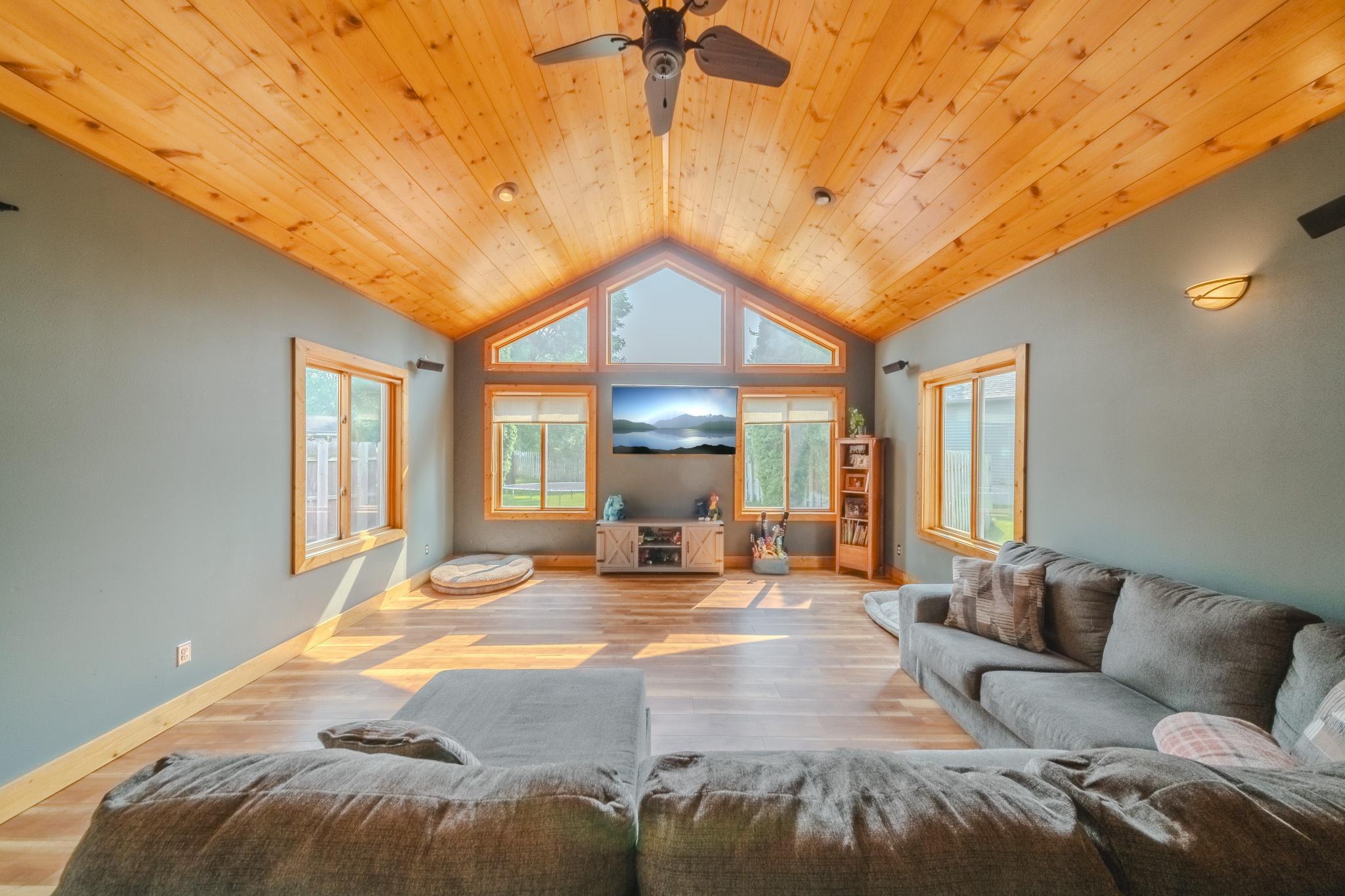 A-frame living room with natural lighting and vaulted ceiling - tv image edited