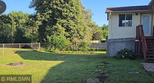 Fenced back yard with steps from Sun room