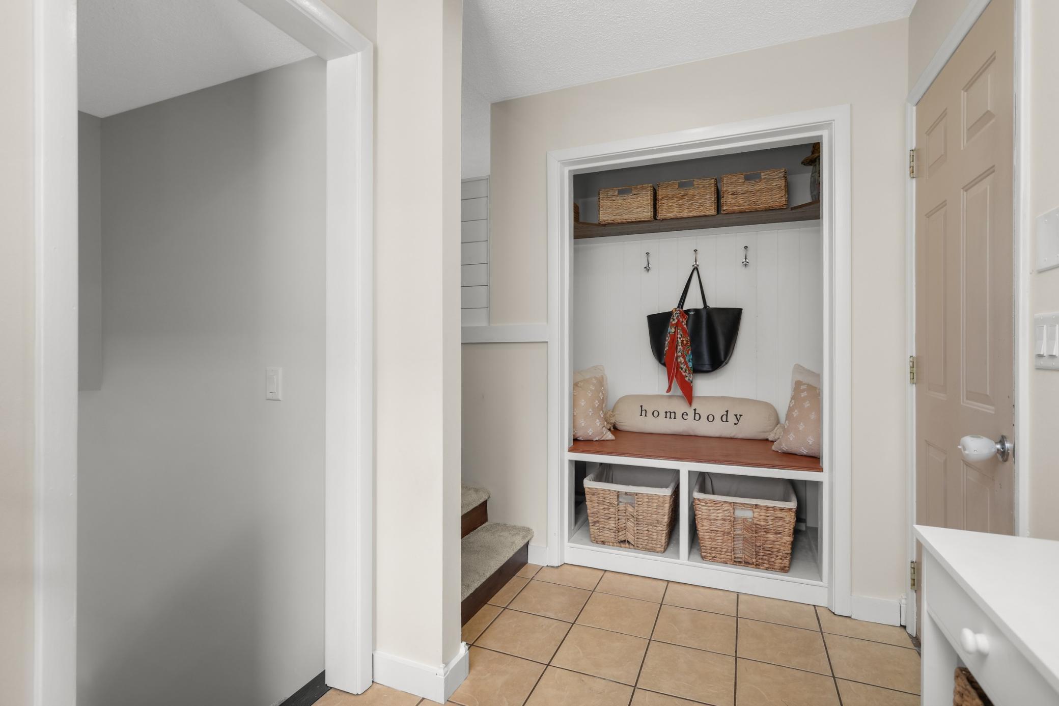 Split entry foyer with built-in storage and door leading to the insulated & heated garage