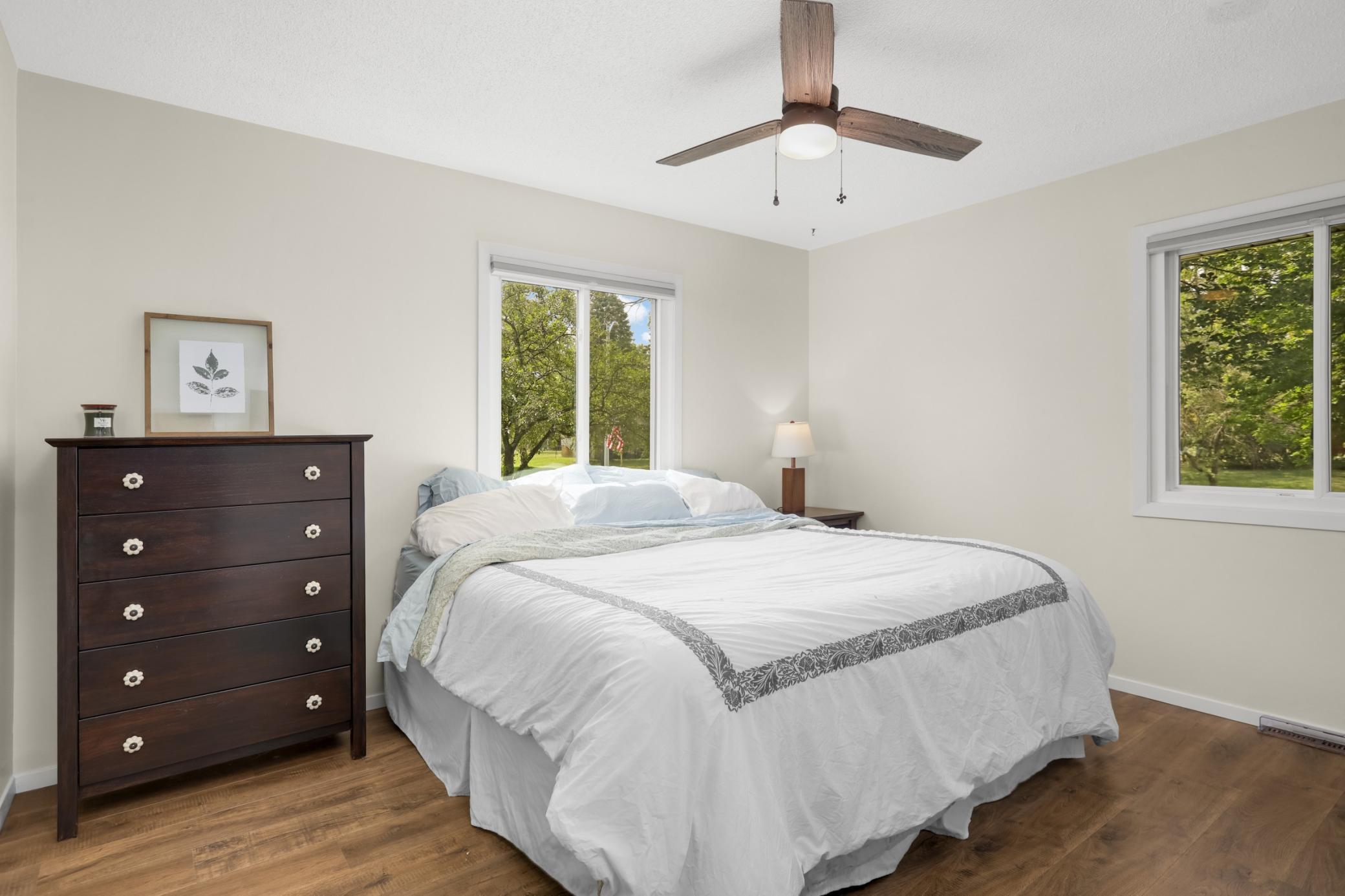 Bedroom #1 on the upper level has vinyl plank flooring and a new ceiling fan