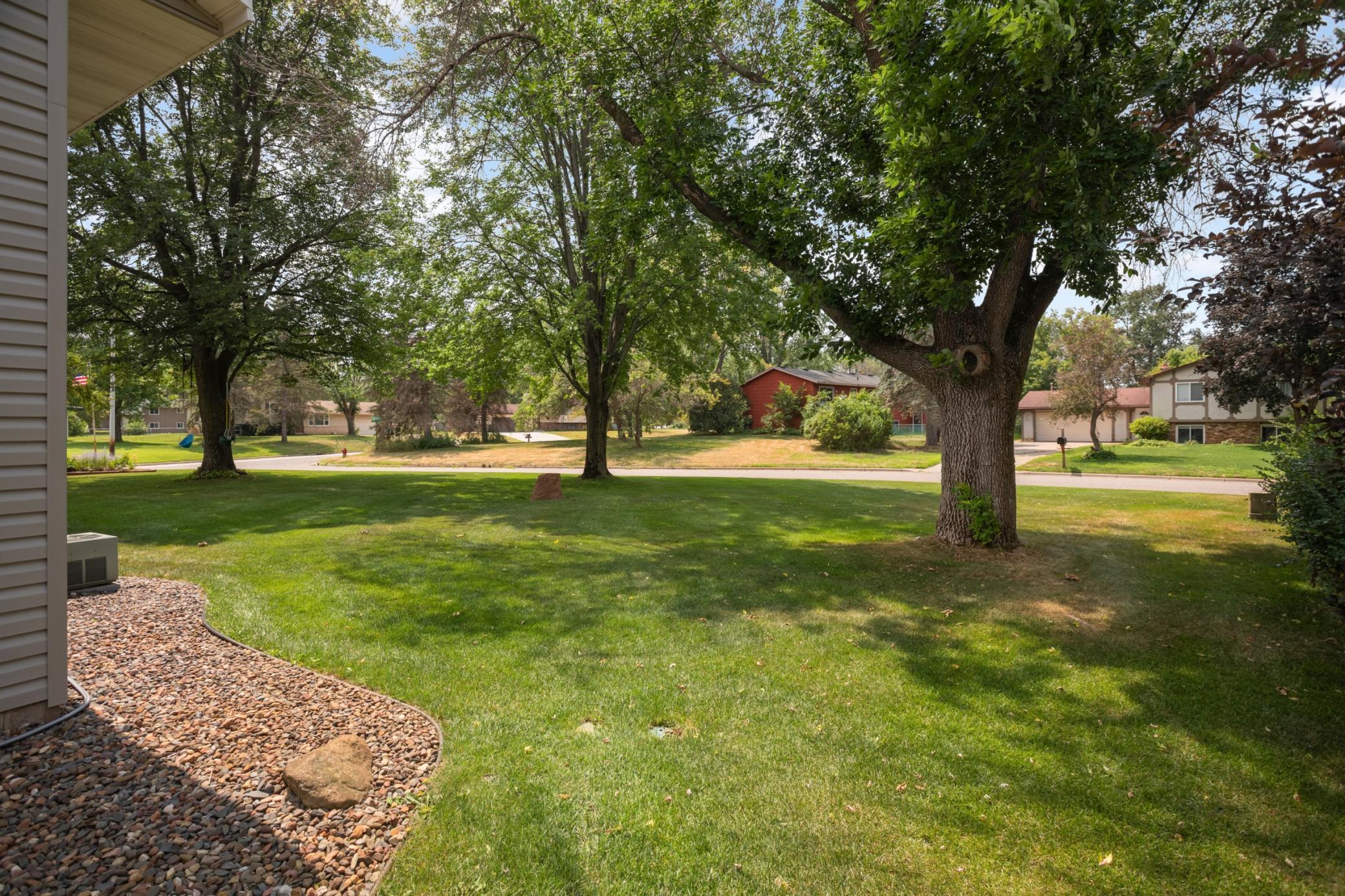 Lovely yard with mature trees and sprinkler system