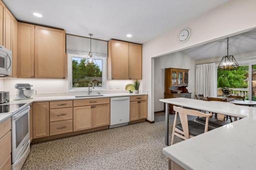 Thoughtfully designed kitchen with generous cabinetry, counter space and recessed lighting.