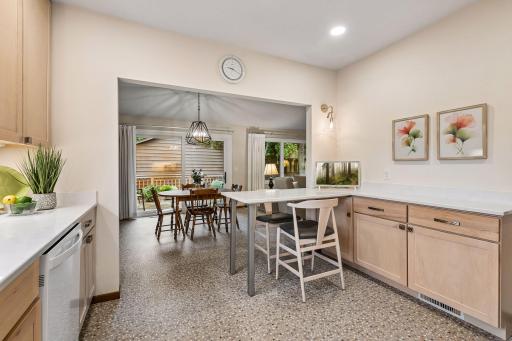 Distinctive Kamdean poured aggregate pebble flooring compliments the kitchen's warm, natural finishes.