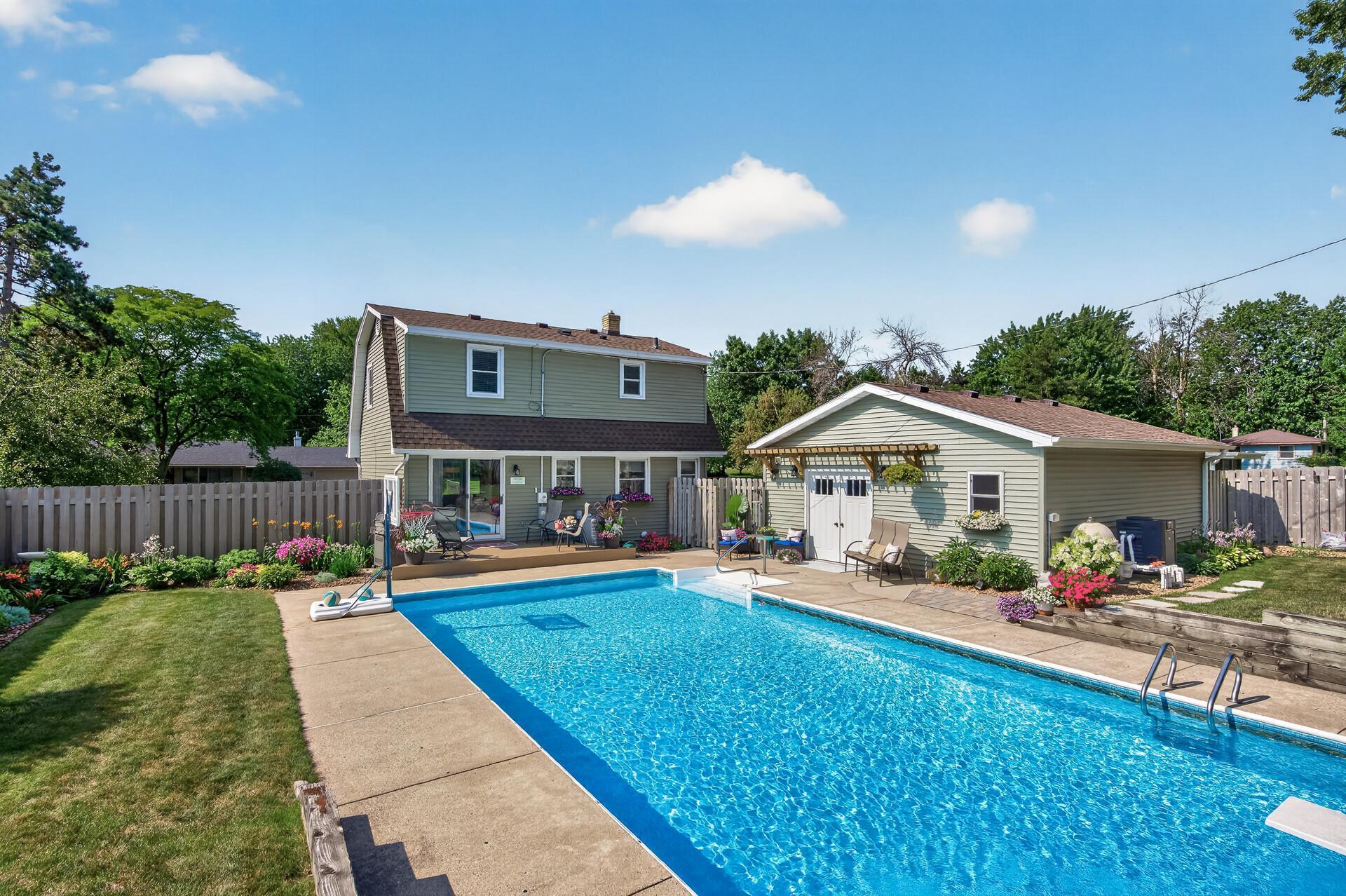 Beautiful back yard with a pool and gorgeous landscaping.