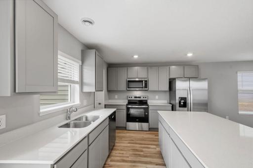 Entertain with ease in this functional kitchen with plenty of counter space. Model photos. Options and colors will vary.