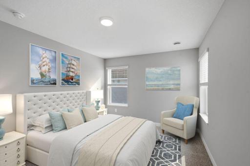 Primary suite including private bath with dual sinks and walk-in closet. Model photos. Options and colors will vary.