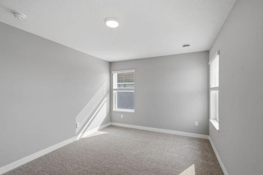 Primary suite including private bath with dual sinks and walk-in closet. Model photos. Options and colors will vary.