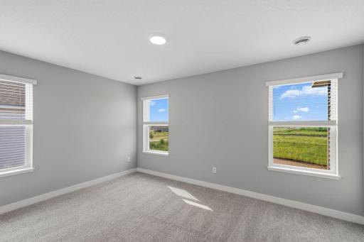 Primary suite including private bath with dual sinks and walk-in closet. Model photos. Options and colors will vary.
