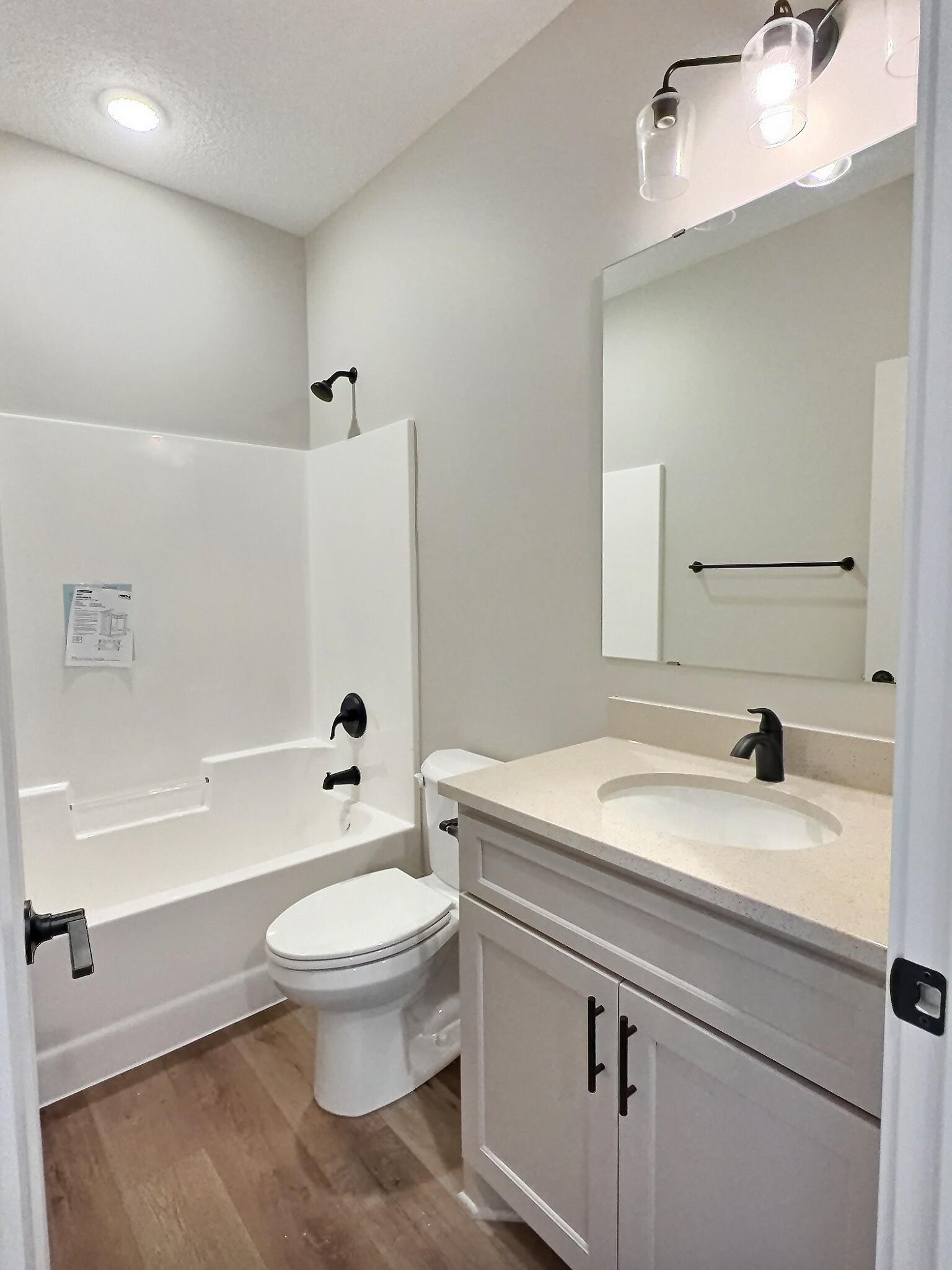 A full bath centers the 2 bedrooms but still located near the the living room. Photo is of current model that is sold.