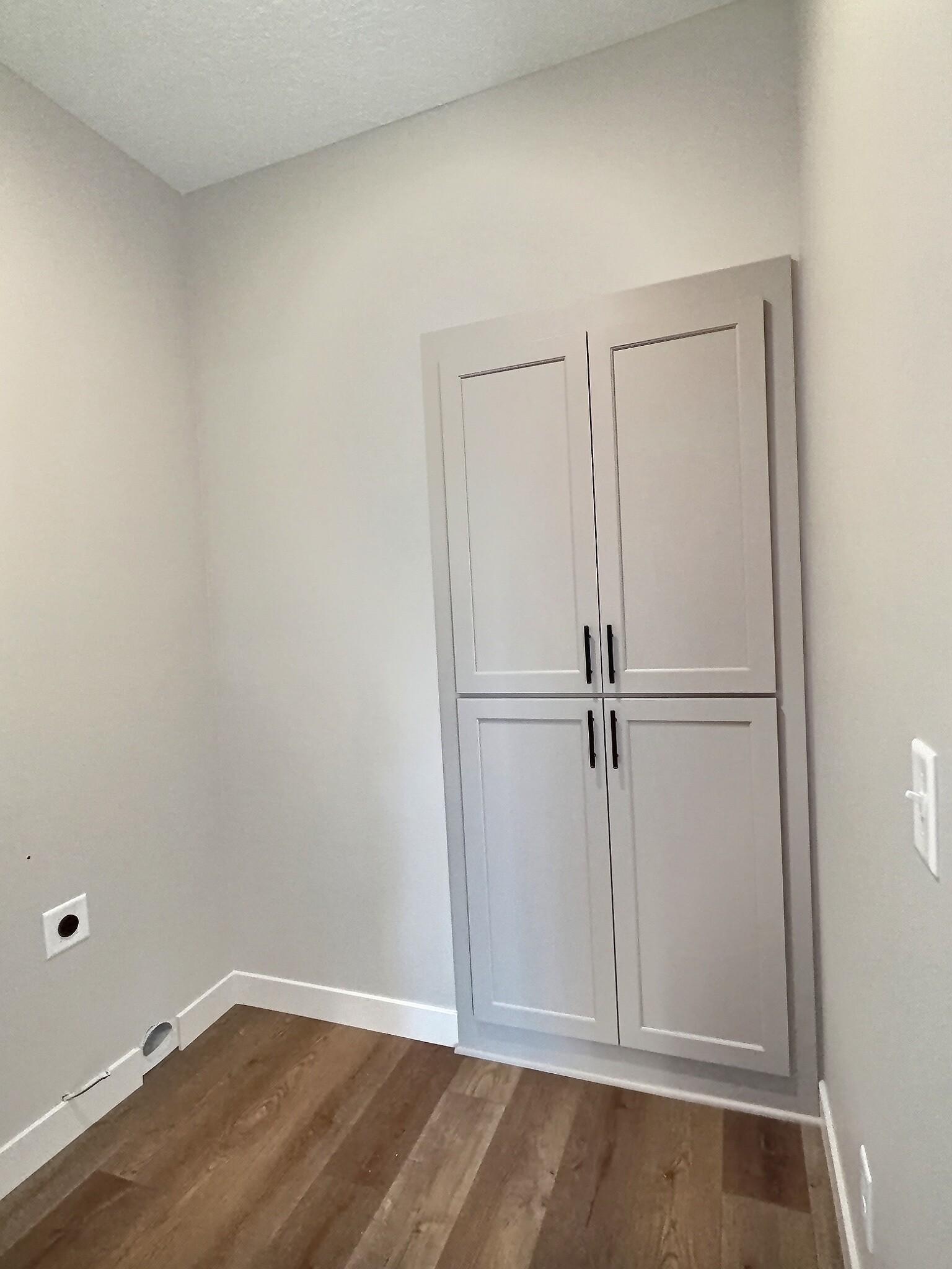 Additional built in cabinet in the laundry room for extra storage in the home. Photo is of current model that is sold.