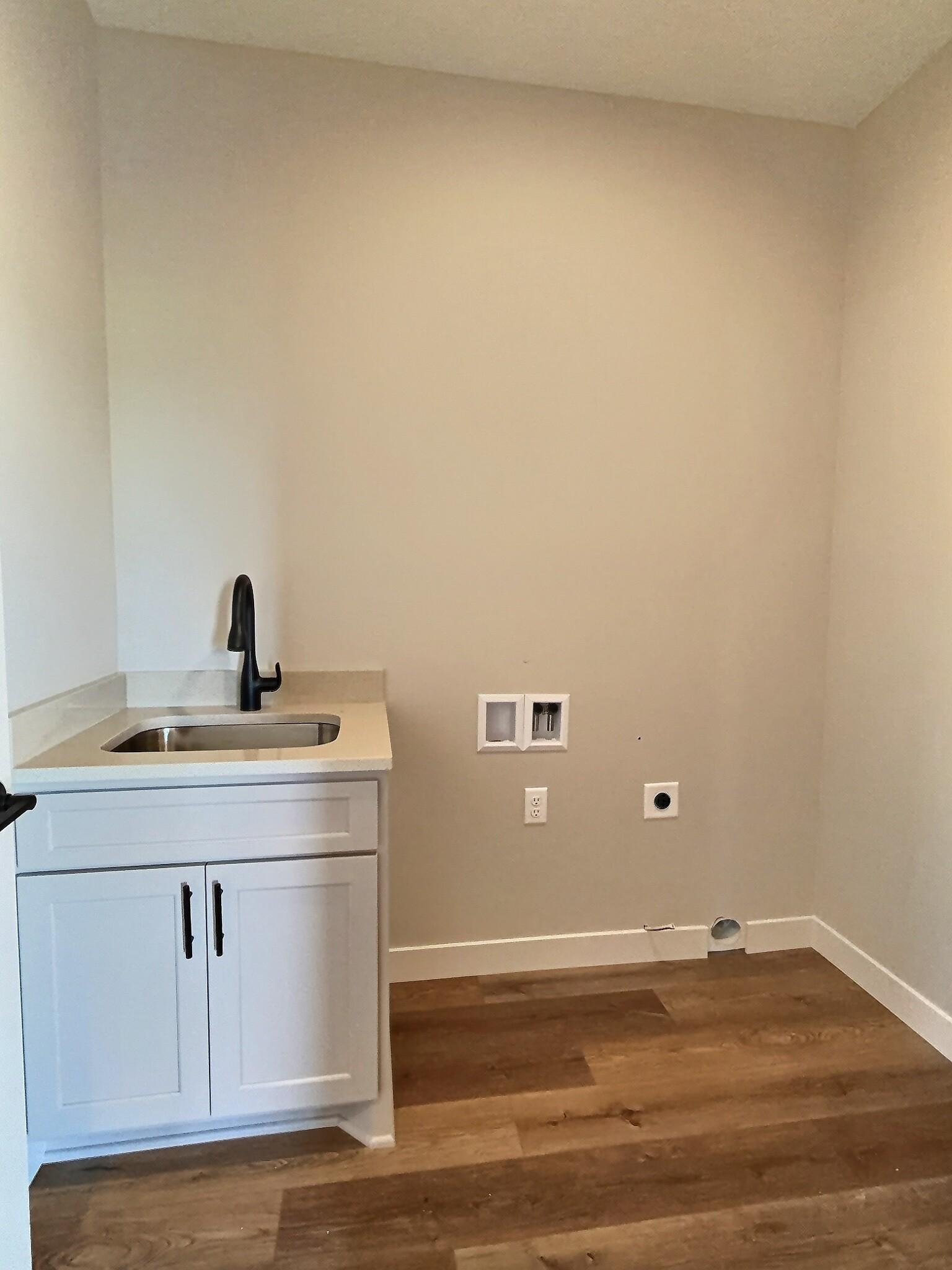 The laundry room is conveniently located outside the primary bedroom for ease of use. Photo is of current model that is sold.