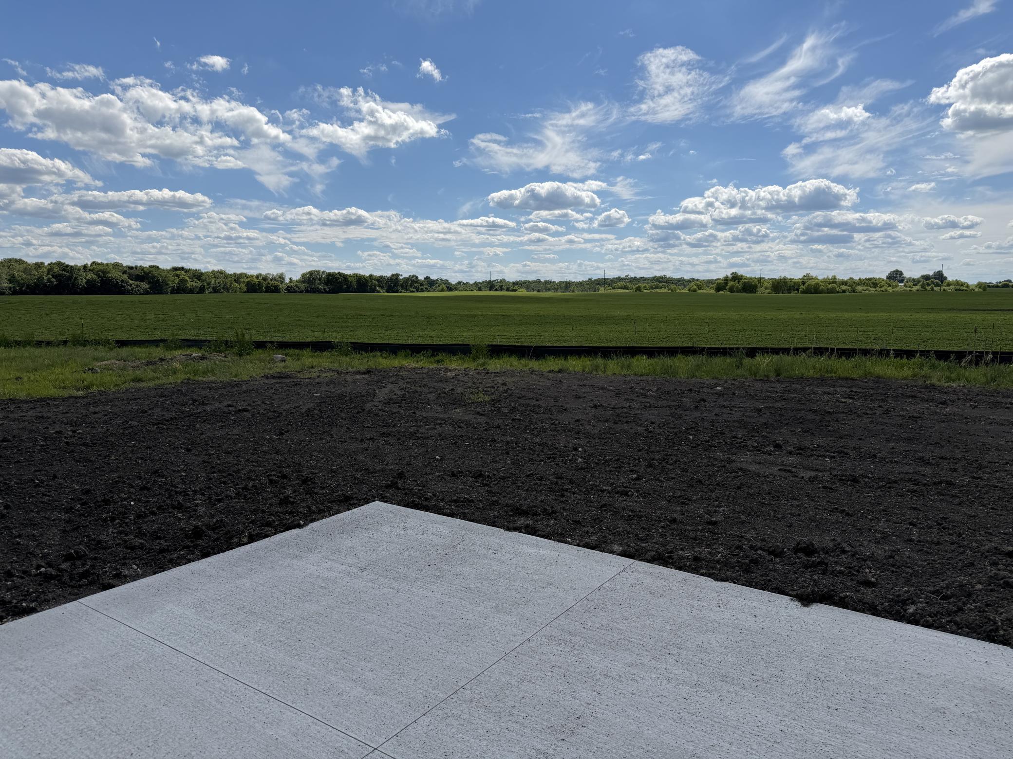 The back patio will have open countryside and sunsets views to boot!! Photo is from current model that is sold.