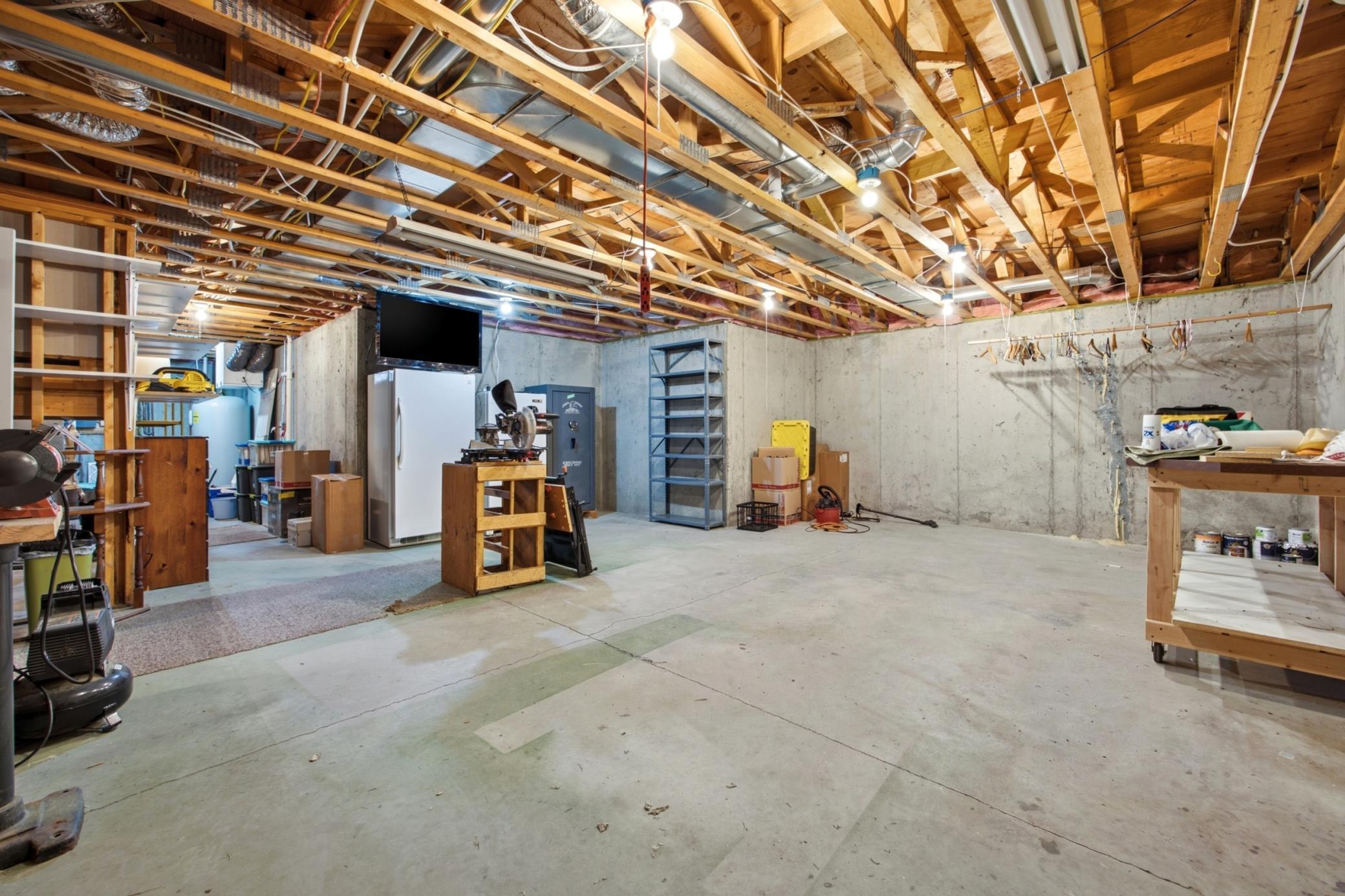 unfinished area - great workshop/gym/storage/office/flex area!