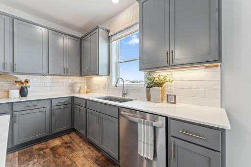 Undermount sink and pull out faucet make clean up a breeze. Photo of model home, colors and finishes are similar.
