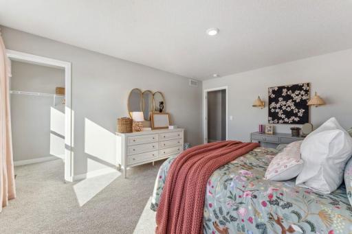 Another view of the secondary bedroom. Photo of model home, colors and finishes are similar.