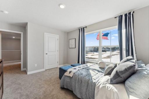 Another view of the bedroom. Photo of model home, colors and finishes are similar.