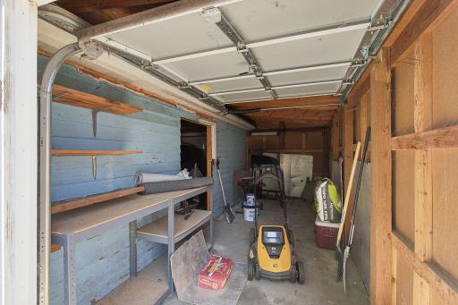 This great space with a rollup door is awesome for lawn equipment and bikes - could also be a nice shop.