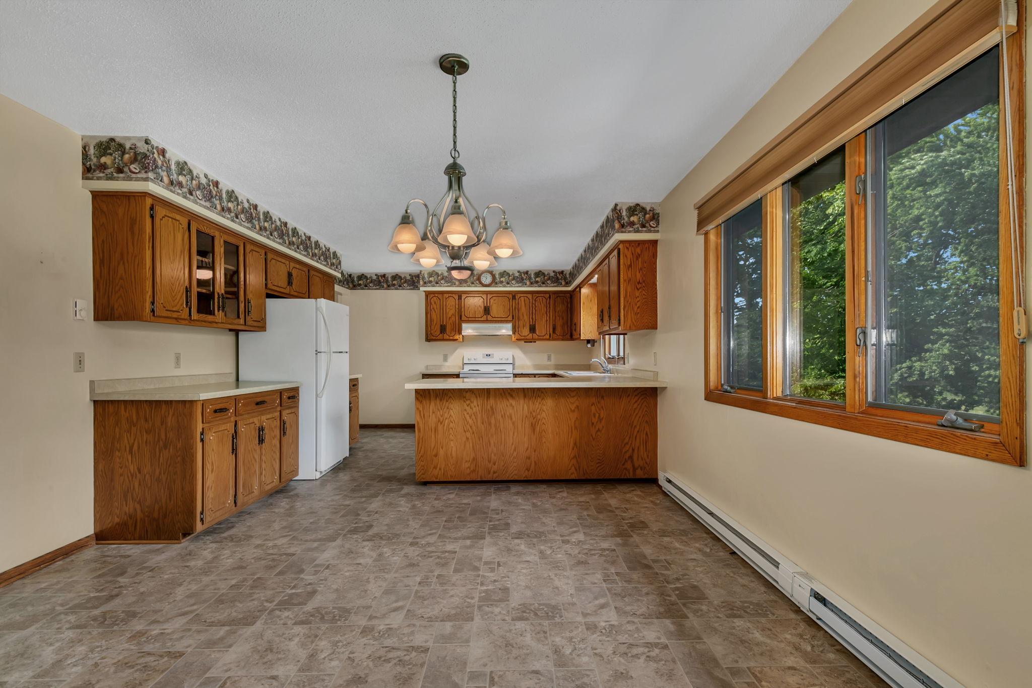 Large dining space that flows nicely from the kitchen. Enjoy the backyard views and natural light that shines in