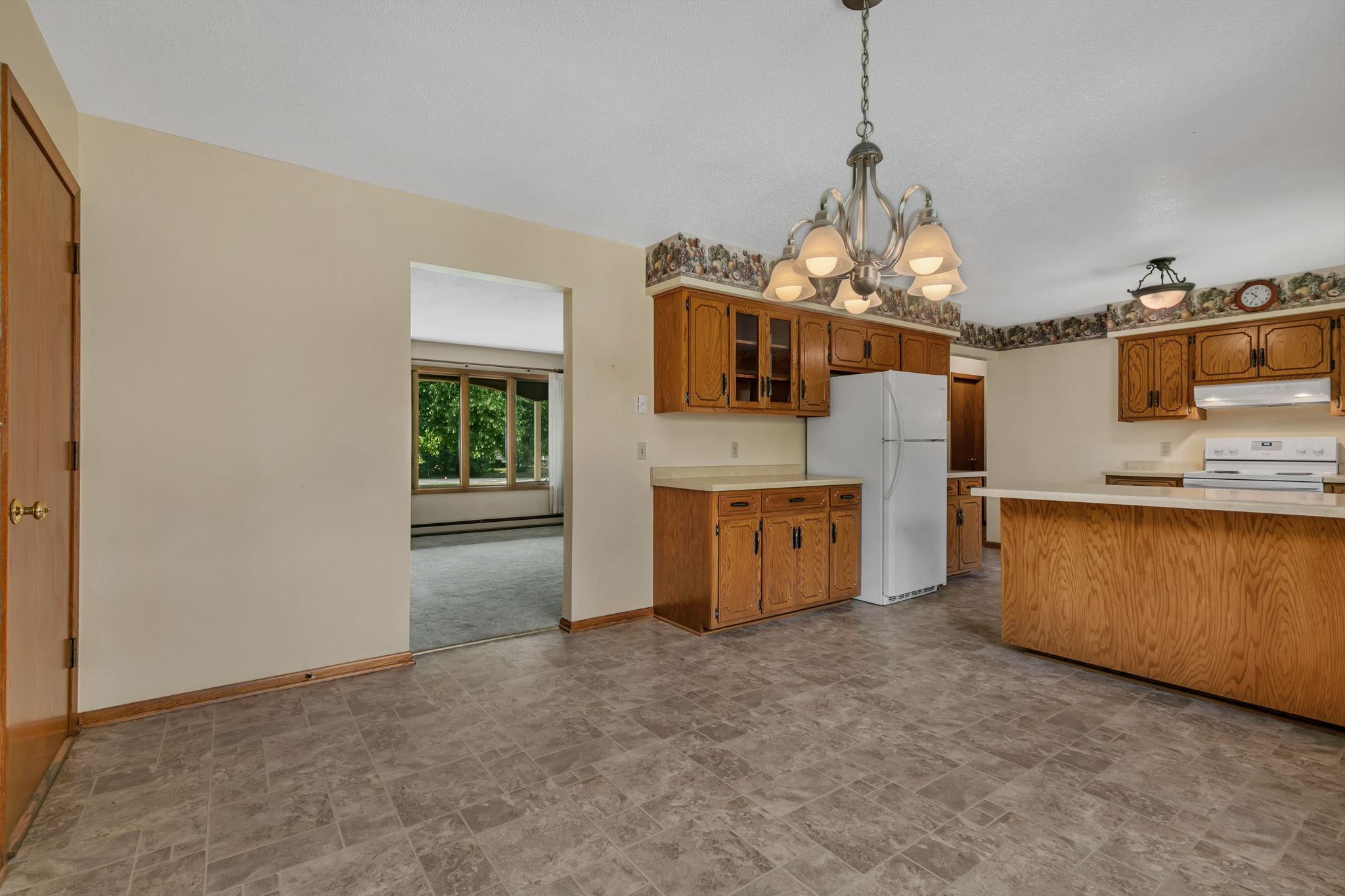 Living room right off the dining and kitchen creates a designated area for each space. Conveinient attached garage access on the left - Easily transport groceries
