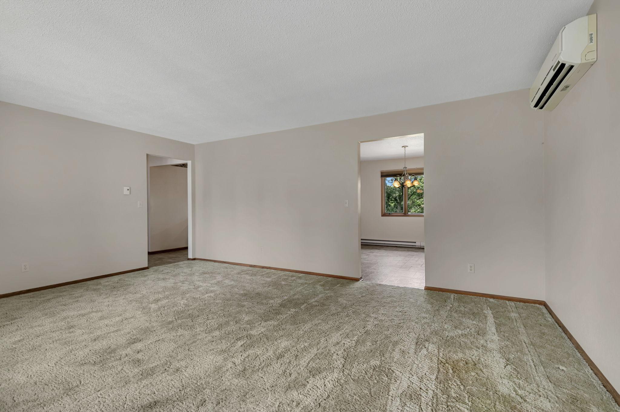 The front living room has access points from the entryway, kitchen and dining.