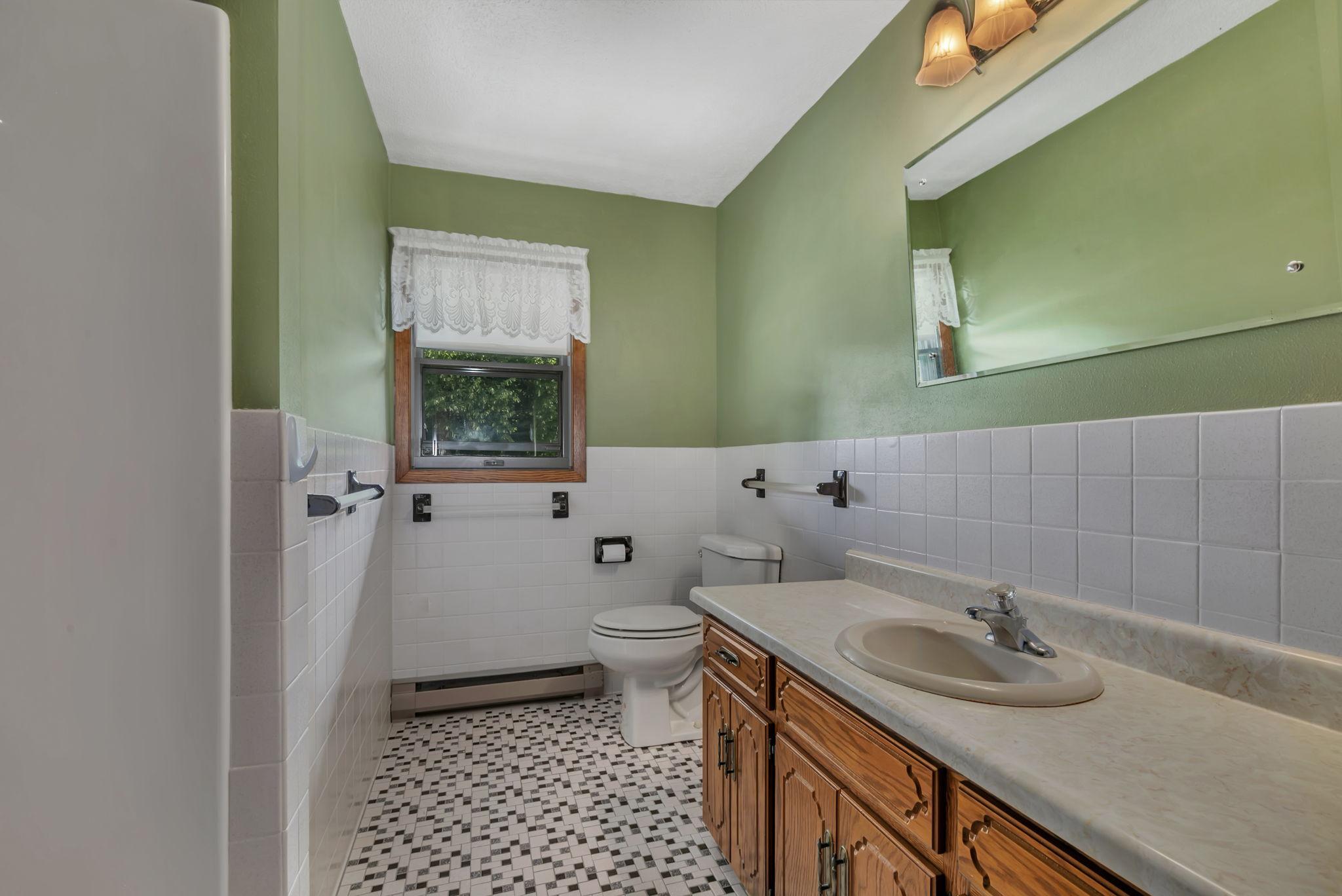 Main level full bathroom offers great counter space