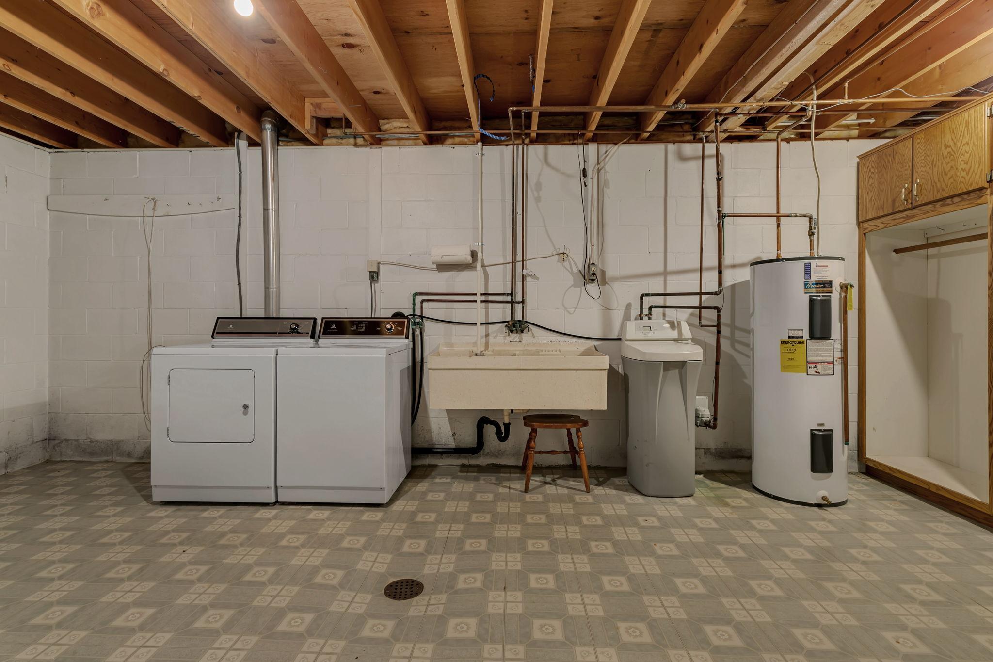 Massive laundry room with large wash tub - loads of storage space