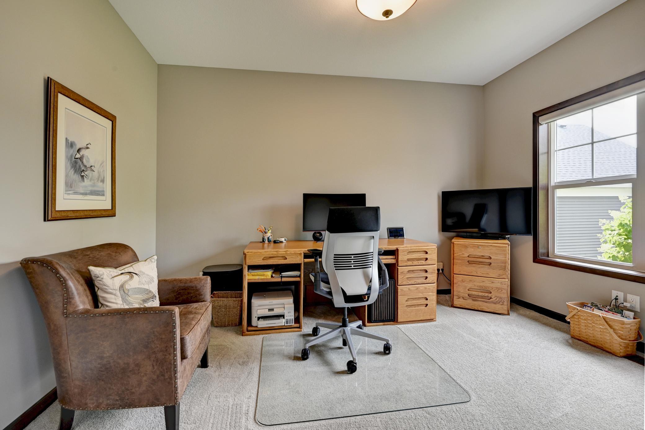 Bright and spacious office off the entry with double doors