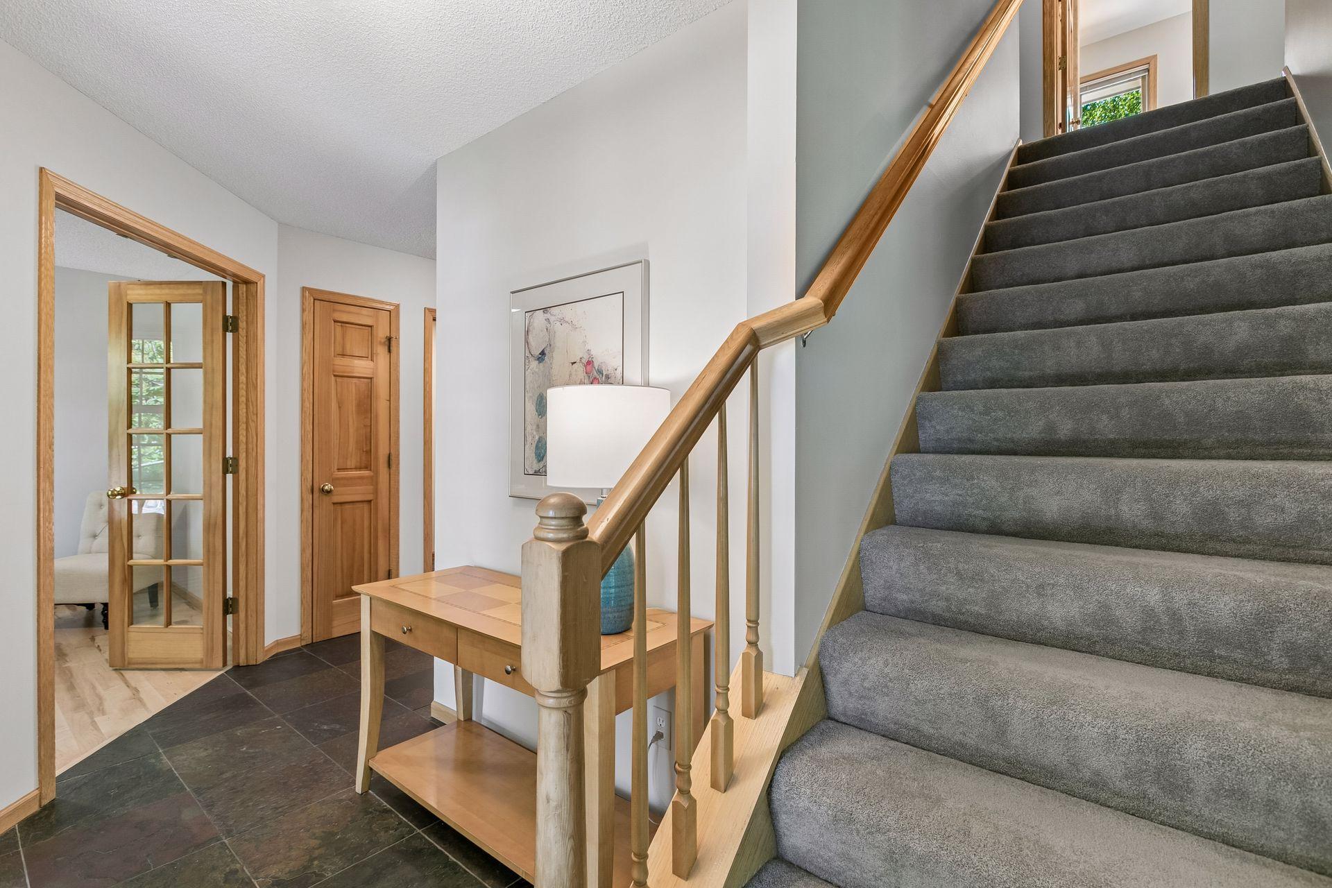 Front entryway with office and closet to the left, upstairs and living room to the right.