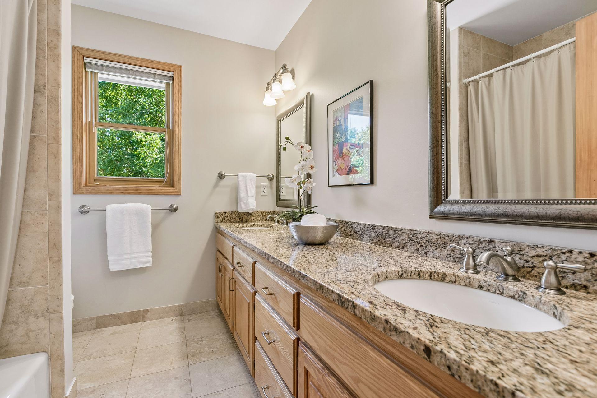 Upstairs full bathroom with double vanity.