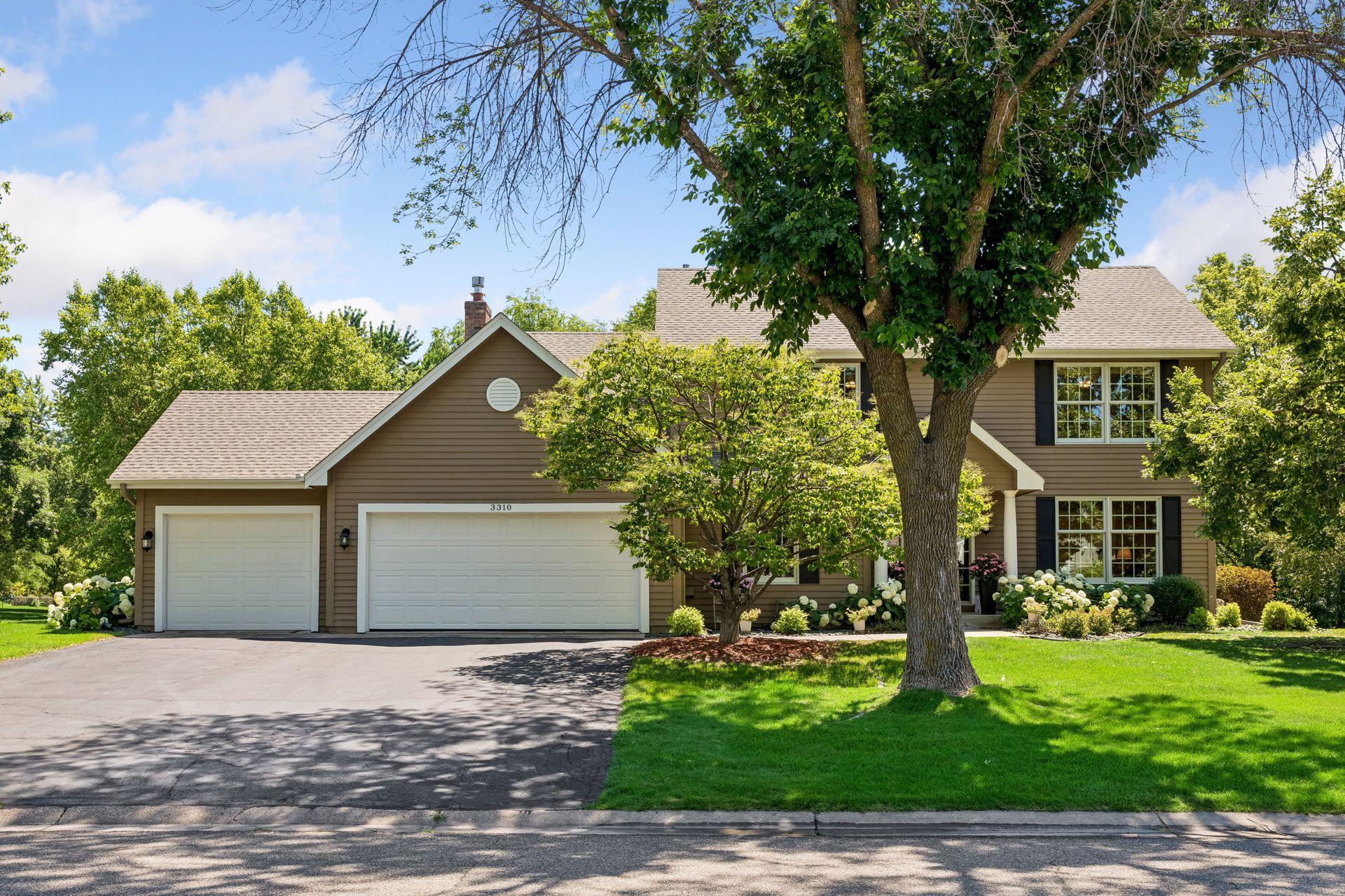Newly sealed driveway with three car garage.