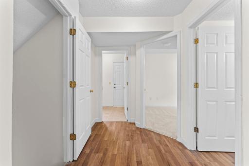 View of Stairway to Lower Level (left), Laundry Room and Garage Entry, Bedroom 4, and Half Bathroom - Main Level