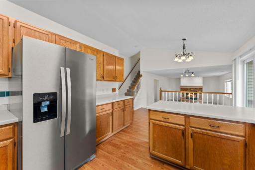 Kitchen - Looking toward Family Room and stairway to upper level (digitally enhanced flame)