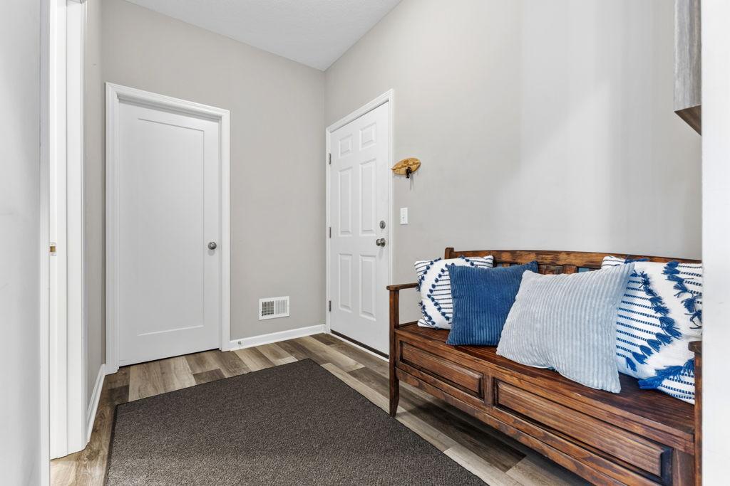Mudroom . The door to the right is to the garage. The door straight ahead is a large walk-in closet. The door to the left of the photo is a half bath.