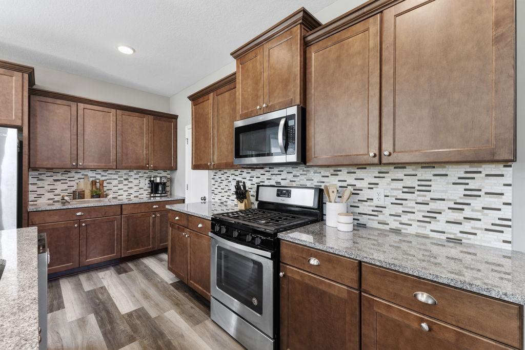 This kitchen has a great amount of counter space as well as storage. The door to the left of the photo is also a walk-in pantry!