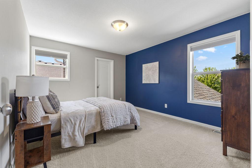 One of the two west facing upper level bedrooms with a walk-in closet.