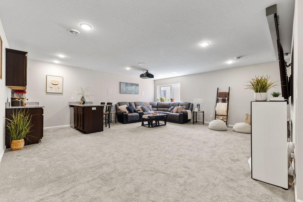 This space has a lot of room for various furniture layouts and placement. To the left of this photo is the 5th bedroom.