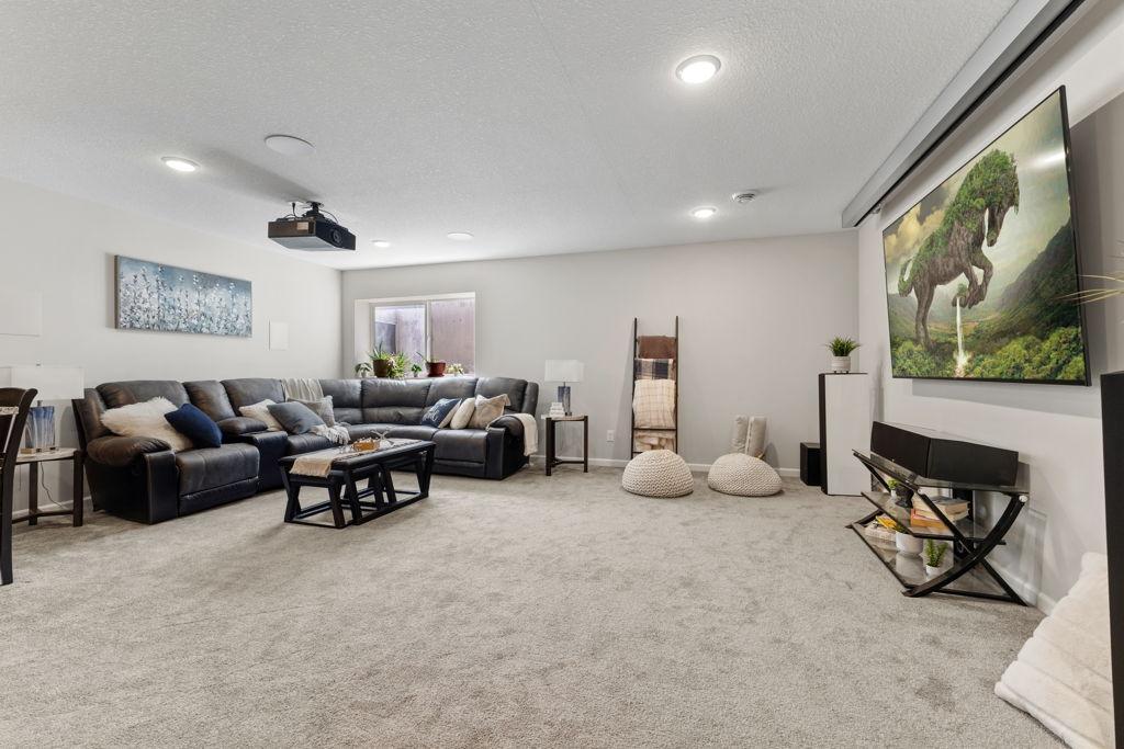 The family room was finished a few years ago with the perfect entertaining set up. Movie nights? Yes please! The window is south facing.