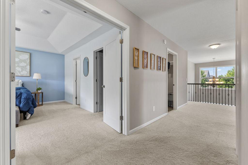 The open door in the hallway on the left is the laundry room. The primary bedroom has double doors that open into a spa-like experience! The first open door to the right in the room is one of the walk-in closets.