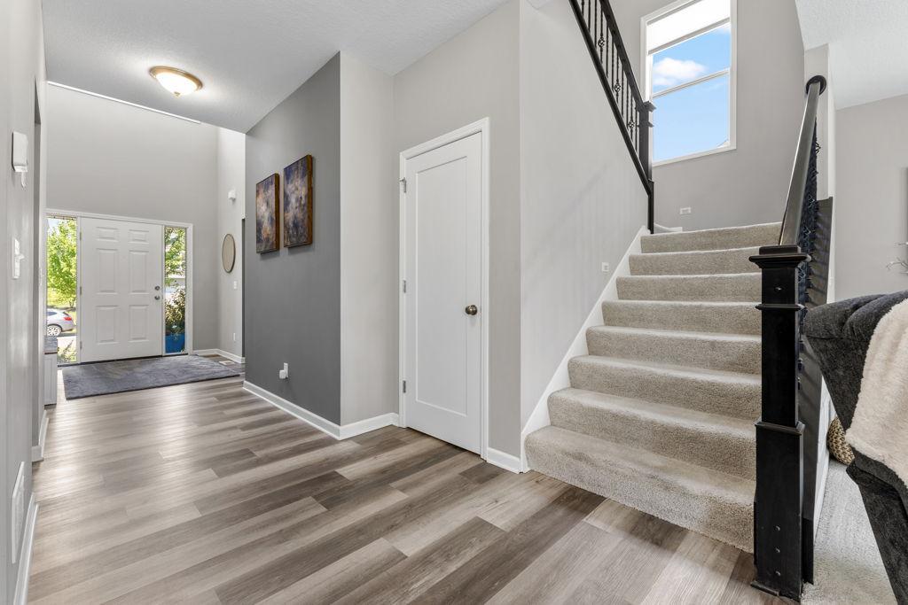 The closed door takes you to the lower level. The staircase takes you up to 4 bedrooms, 2 bathrooms, and a laundry room.