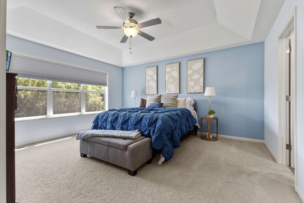 The photo is with a king sized bed so plenty of room for extra in this space. The door to the right takes you to the primary bathroom.
