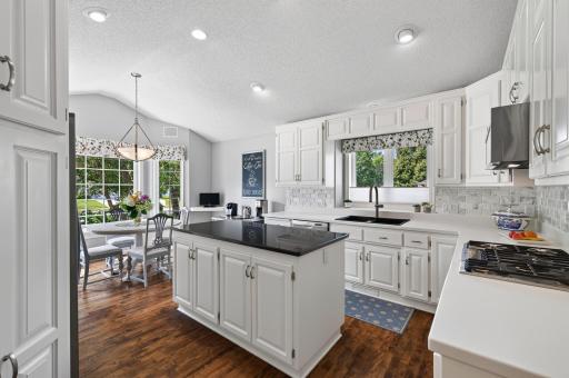 Beautifully updated with timeless finishes, an Italian marble backsplash, and maple hardwood flooring.
