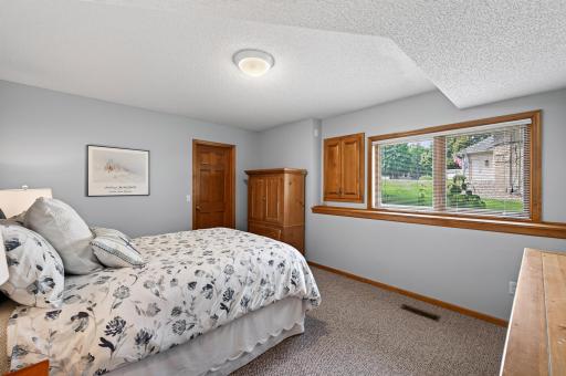 Spacious and inviting, this lower-level bedroom offers comfort, privacy, and flexibility for guests or extended family.