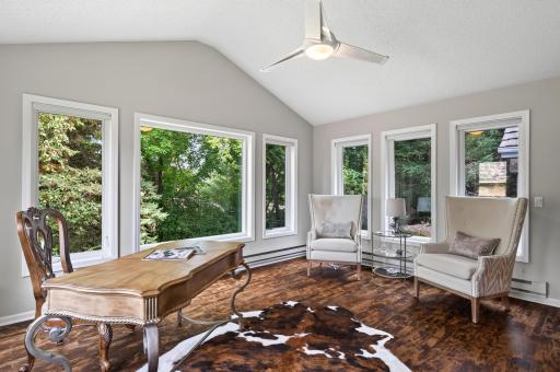 The perfect sunroom to enjoy your morning coffee while overlooking the tranquil waterfall and mature landscaping.