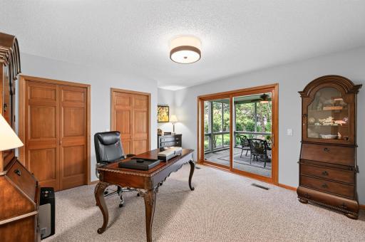 Whether used as a private guest bedroom or inspiring home office, this versatile space offers direct access to the beautiful screened porch and peaceful backyard retreat.